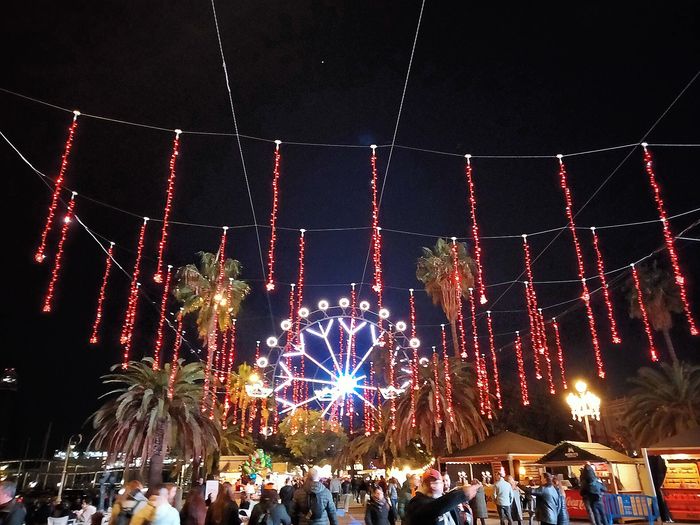Nadal al Port at night, with red lights among the palms and the lit big wheel (photographed in 2023).