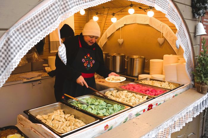 A vendor with pierogi in a wooden hut on the Main Square.