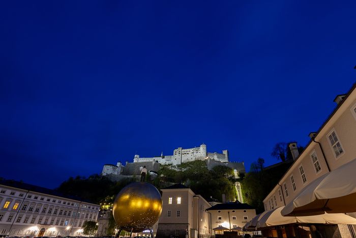Hohensalzburg Fortress at blue hour above Kapitelplatz.