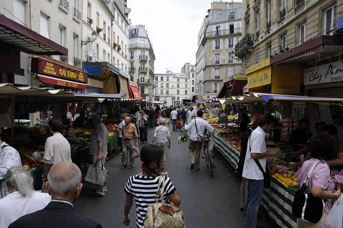 Rue d'Aligre in the 12th arrondissement. The market is closed on Mondays, and the covered hall beside the street keeps its own hours.