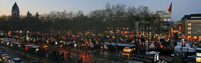 Neumarkt at dusk, with the stalls set out under bare trees.