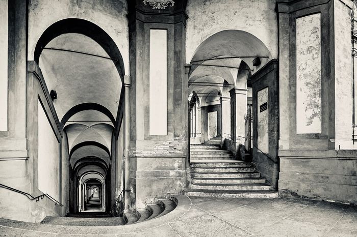 Most of a Bologna day is spent under the arcades. They are why a bad forecast does not move the schedule here.